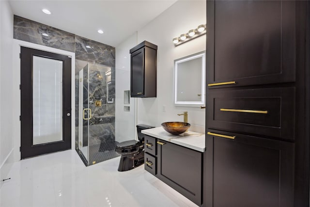 bathroom featuring a shower with door, vanity, and toilet