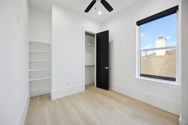 unfurnished bedroom featuring light wood-type flooring and ceiling fan