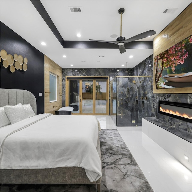 bedroom with ceiling fan and a high end fireplace