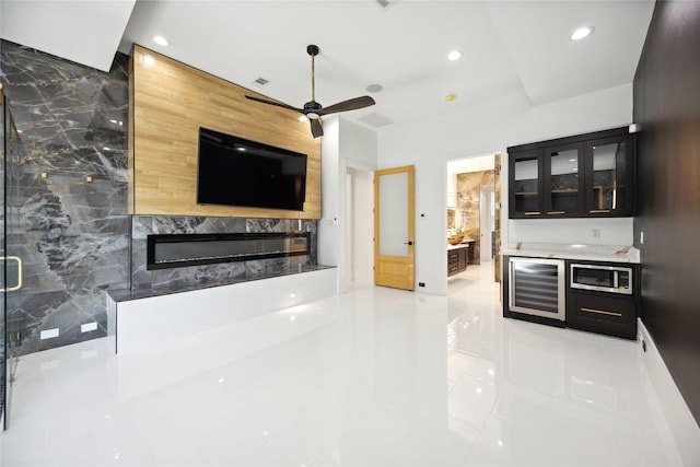 living room with ceiling fan, beverage cooler, and tile walls