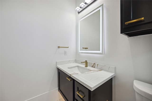 bathroom with vanity and toilet