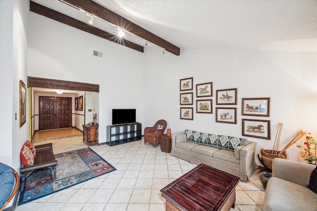 living room with beam ceiling, a textured ceiling, high vaulted ceiling, and light tile patterned flooring