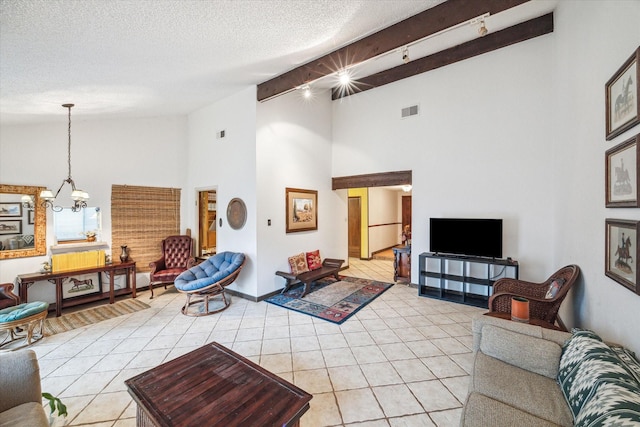 tiled living room with beam ceiling, a textured ceiling, high vaulted ceiling, and an inviting chandelier