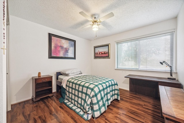 bedroom featuring a textured ceiling, dark hardwood / wood-style flooring, and ceiling fan