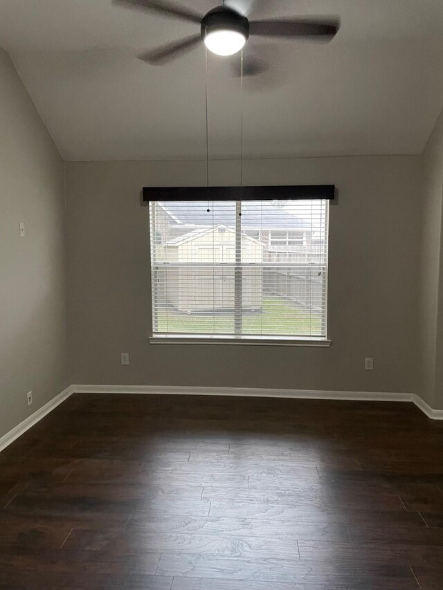 spare room featuring lofted ceiling, dark wood-type flooring, and ceiling fan