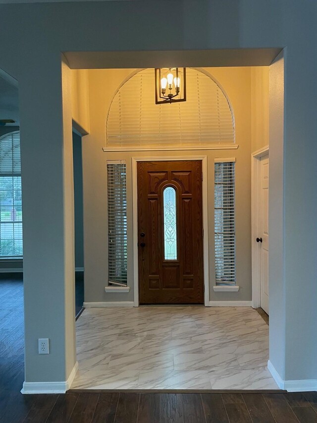 foyer featuring a chandelier