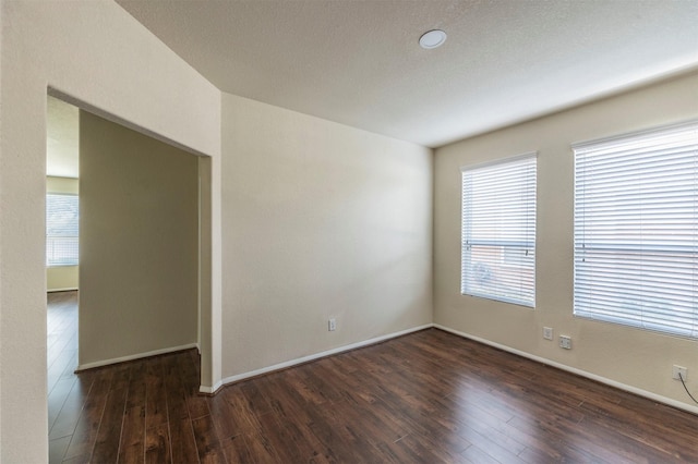 spare room featuring dark hardwood / wood-style flooring