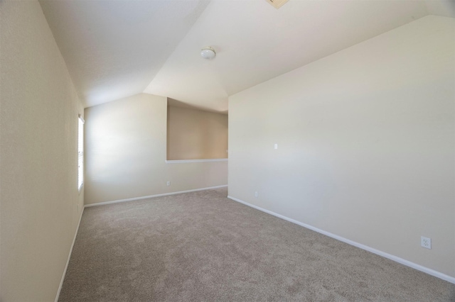 interior space featuring carpet floors and lofted ceiling