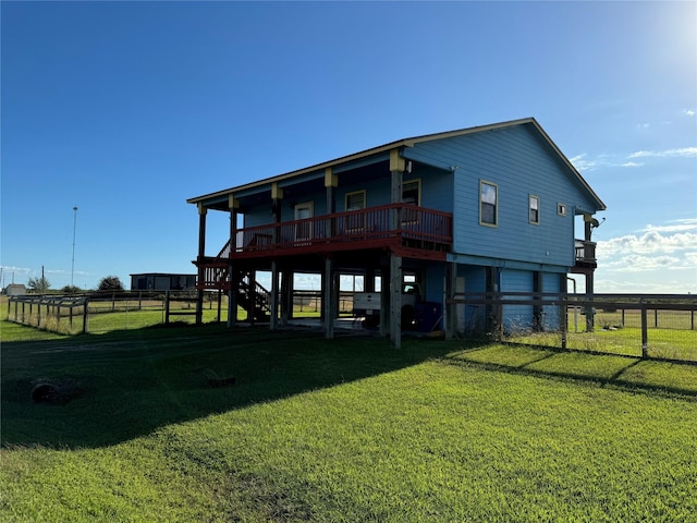 rear view of property featuring a yard