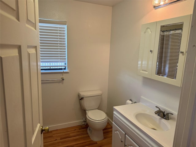 bathroom featuring vanity, toilet, and wood-type flooring