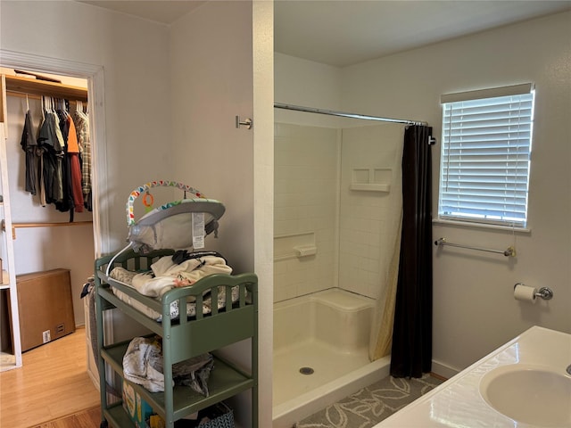 bathroom featuring a shower with curtain, hardwood / wood-style floors, and sink