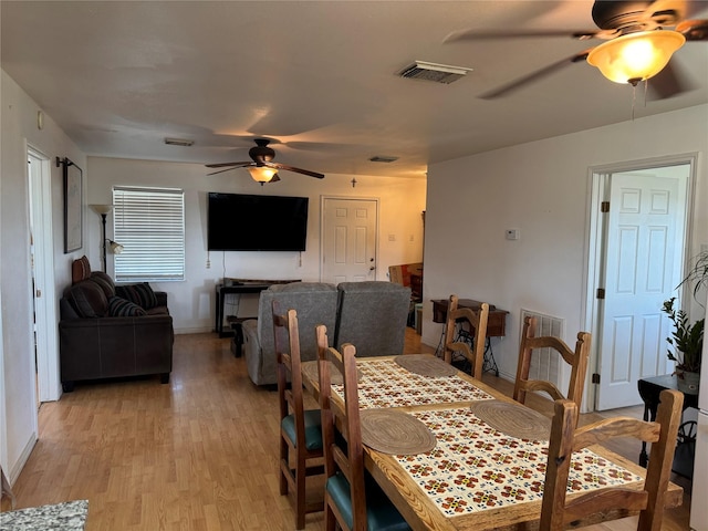 dining space with light hardwood / wood-style floors and ceiling fan