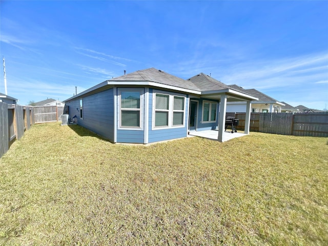 back of property featuring cooling unit, a patio area, and a yard