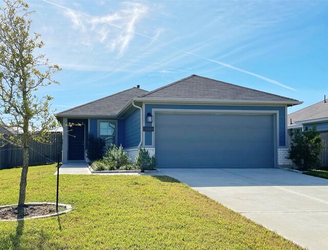 ranch-style house featuring a garage and a front yard