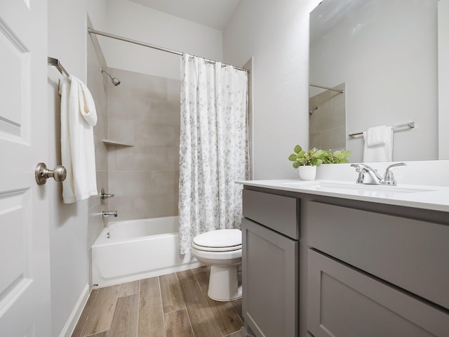 full bathroom featuring hardwood / wood-style floors, vanity, toilet, and shower / tub combo with curtain