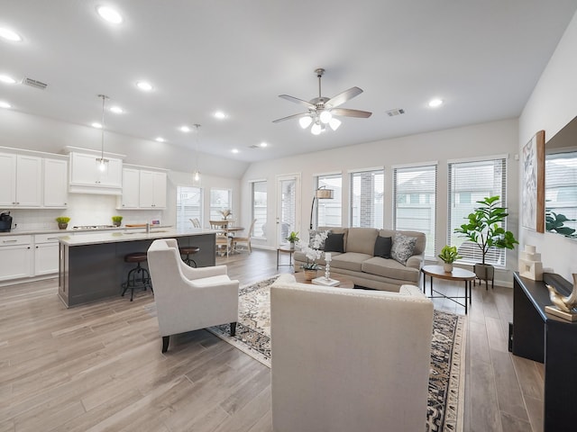 living room featuring ceiling fan and light wood-type flooring