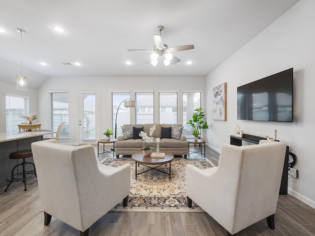 living room featuring hardwood / wood-style flooring, plenty of natural light, and lofted ceiling