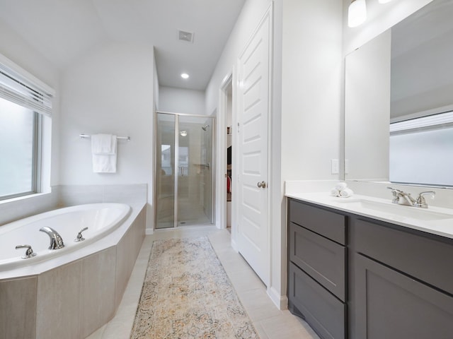 bathroom with tile patterned floors, vanity, lofted ceiling, and plus walk in shower