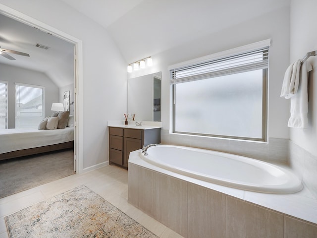 bathroom with tile patterned flooring, vanity, ceiling fan, and vaulted ceiling