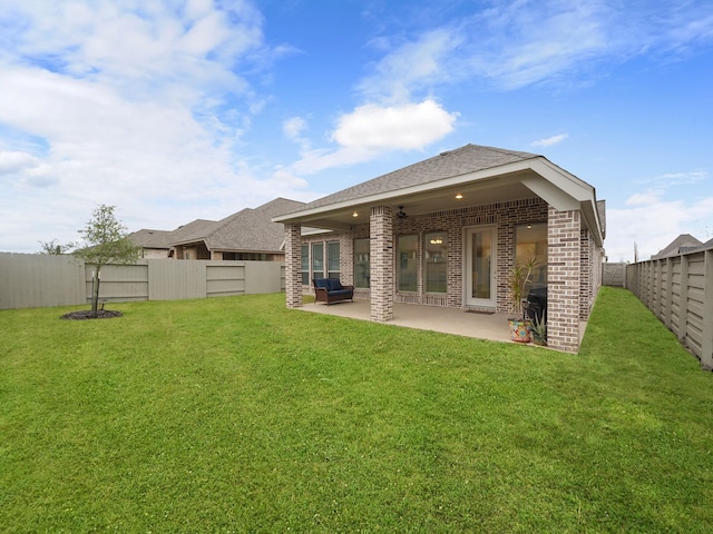 back of property featuring a patio area and a yard