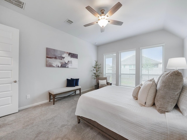 bedroom with ceiling fan, light carpet, and vaulted ceiling