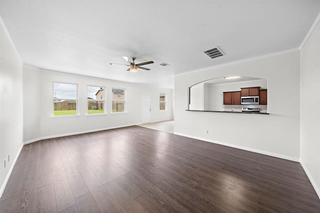 unfurnished living room with ceiling fan, crown molding, and dark wood-type flooring