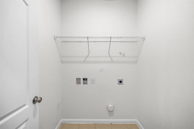 clothes washing area featuring hookup for a gas dryer, hookup for a washing machine, light tile patterned flooring, and hookup for an electric dryer