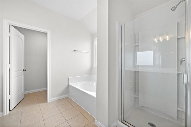 bathroom featuring tile patterned floors, lofted ceiling, and independent shower and bath