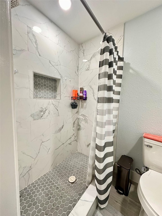 bathroom with a shower with curtain and toilet