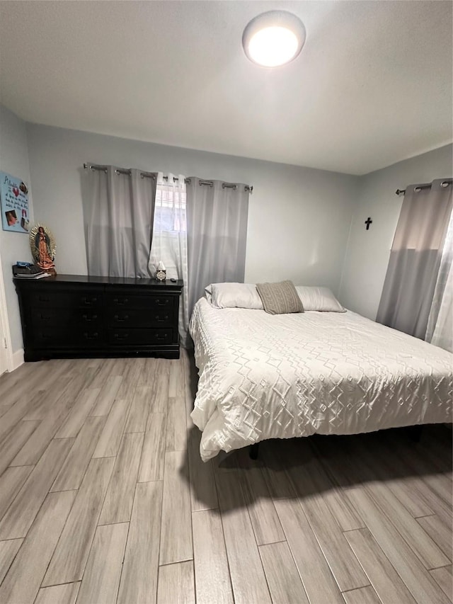 bedroom with light wood-type flooring