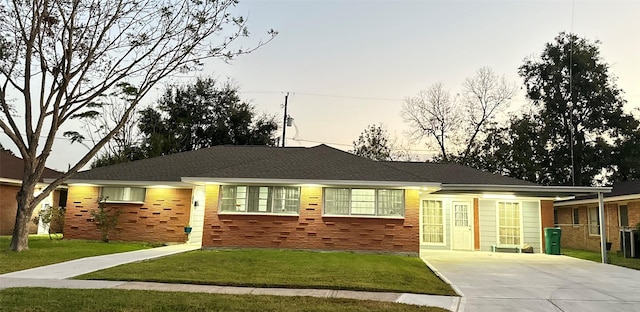 ranch-style home featuring a lawn