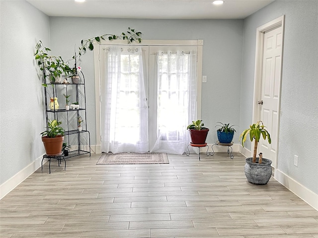 doorway to outside with light hardwood / wood-style floors