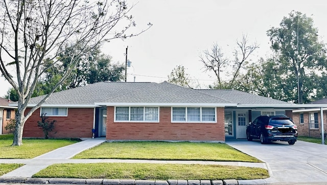 ranch-style house featuring a carport and a front lawn