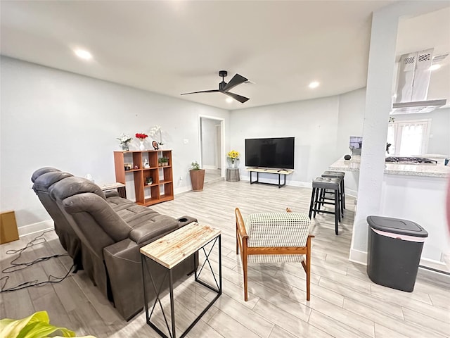 living room featuring ceiling fan and light hardwood / wood-style flooring