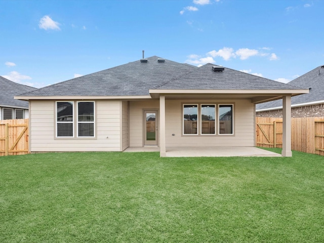 rear view of property featuring a patio area and a yard