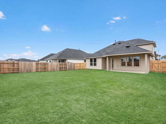 back of house featuring a yard and a patio area