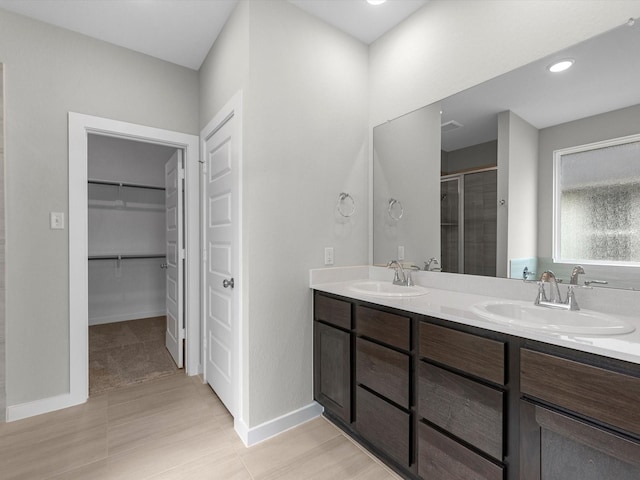 bathroom featuring vanity and a shower with door