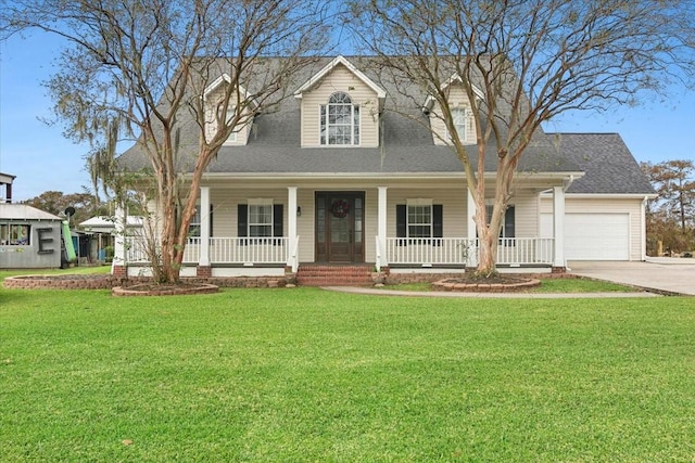 cape cod home featuring a garage and a front yard