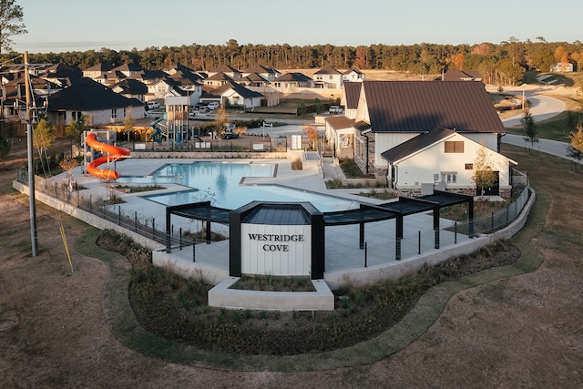 view of swimming pool with a water slide