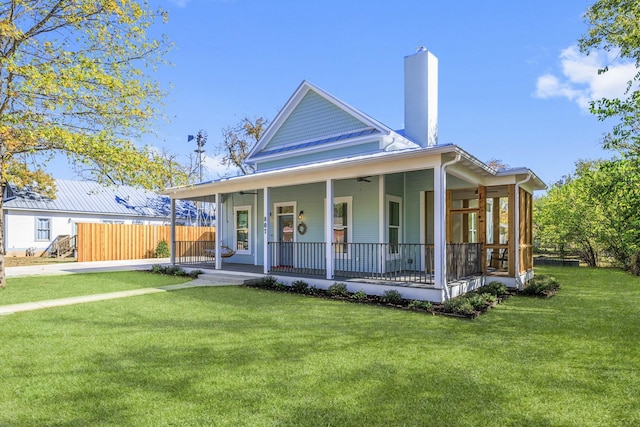 farmhouse featuring a front lawn and covered porch