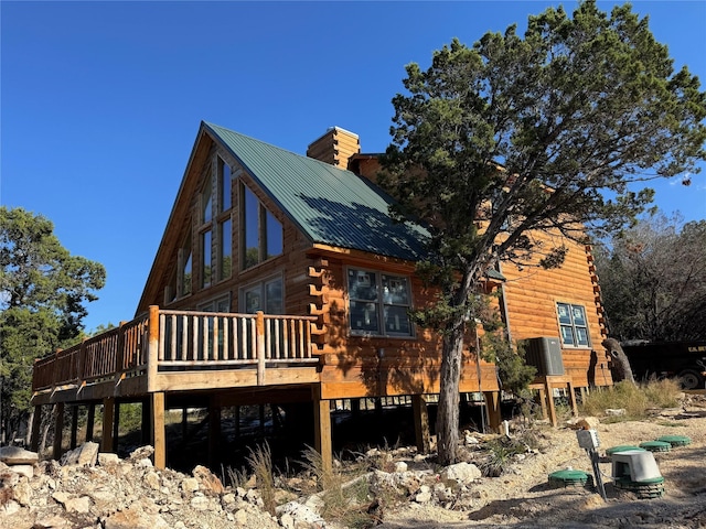 back of house featuring a wooden deck and central AC unit