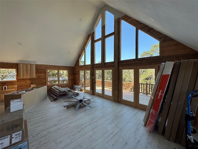 sunroom with a wealth of natural light, french doors, and vaulted ceiling