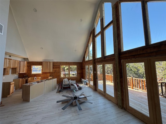 sunroom featuring a healthy amount of sunlight, ceiling fan, and french doors