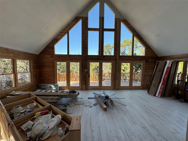 interior space featuring ceiling fan, high vaulted ceiling, and light hardwood / wood-style floors