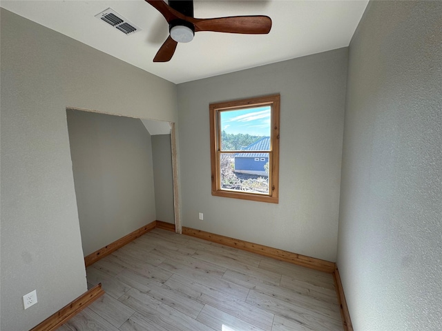 spare room featuring ceiling fan and light hardwood / wood-style flooring