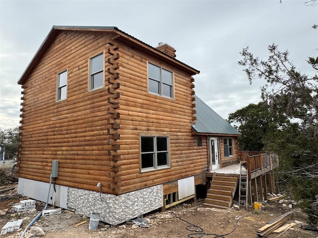 back of house with a deck