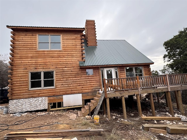 rear view of property featuring a deck