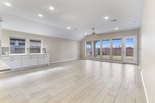 unfurnished living room featuring light wood-type flooring, ceiling fan, and lofted ceiling