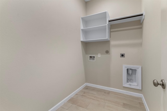 washroom with hookup for a gas dryer, light hardwood / wood-style flooring, washer hookup, and hookup for an electric dryer