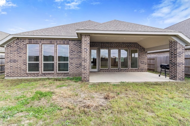 back of house with a yard and a patio area